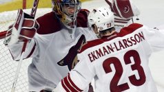 Phoenix Coyotes goalie Mike Smith celebrates defeating the Chicago Blackhawks with teammate Oliver Ekman-Larsson following Game 6 of their NHL Western Conference quarter-final playoff hockey game
