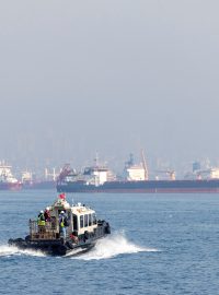 Zaměstnanci koordinačního centra míří k lodi v Bosporském  průlivu, kterým prochází i lodě z Ukrajiny.