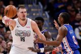 Jokić kontroluje míč pod tlakem protihráčů Philadelphie