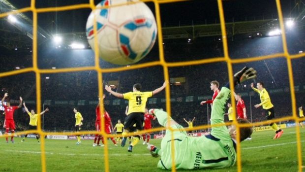 Borussia Dortmund&#039;s Robert Lewandowski (19) celebrates his goal against Bayern Munich goalie Manuel Neuer during their German first division Bundesliga soccer match