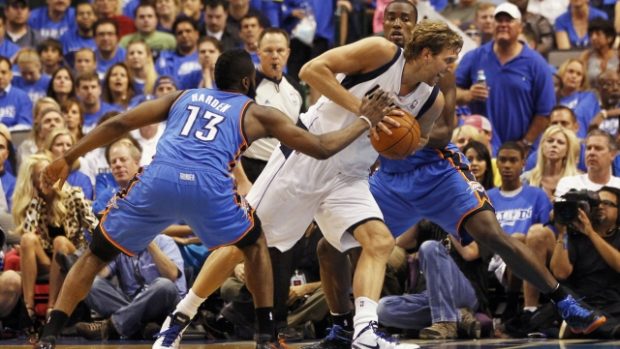 Dallas Mavericks forward Dirk Nowitzki  (C) is defended by Oklahoma City Thunder guard James Harden (L) and forward Serge Ibaka during the second half of their NBA Western Conference quarter-final playoff basketball game in Dallas, Texas May 5, 2012