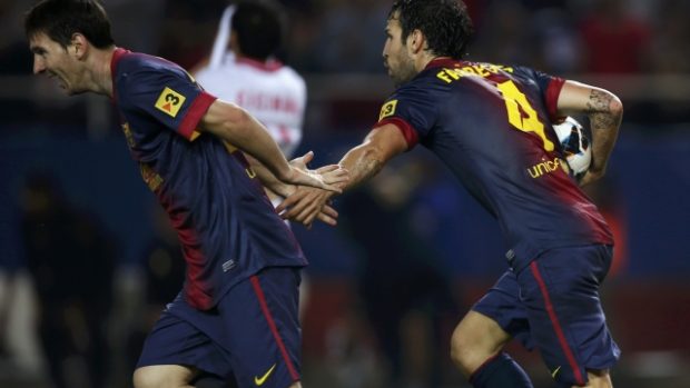 Barcelona&#039;s Cesc Fabregas (R) is congratulated by Lionel Messi after scoring against Sevilla  during their Spanish First Division soccer match at Ramon Sanchez Pizjuan stadium in Seville September 29, 2012