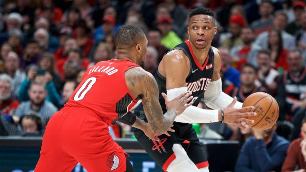 Hvězda Portlandu Damian Lillard brání Russella Westbrooka z Houstonu Rockets