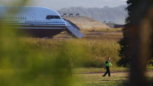 Britští policisté u letadla, které mělo odvézt první migranty do Rwandy