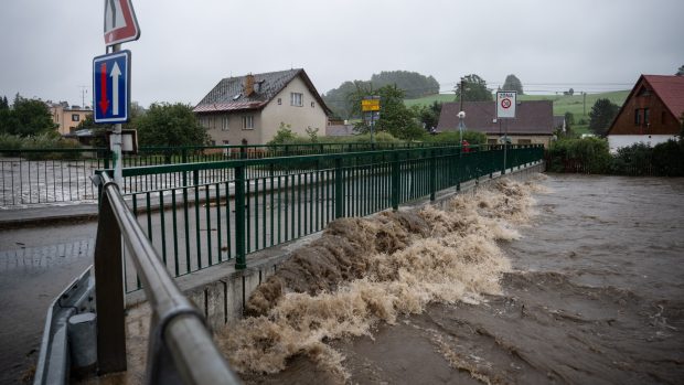 Říčka Bělá v Písečné začíná přetékat přes most