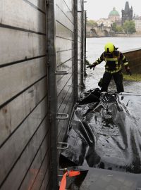 Hasič staví protipovodňové zábrany na Kampě v Praze